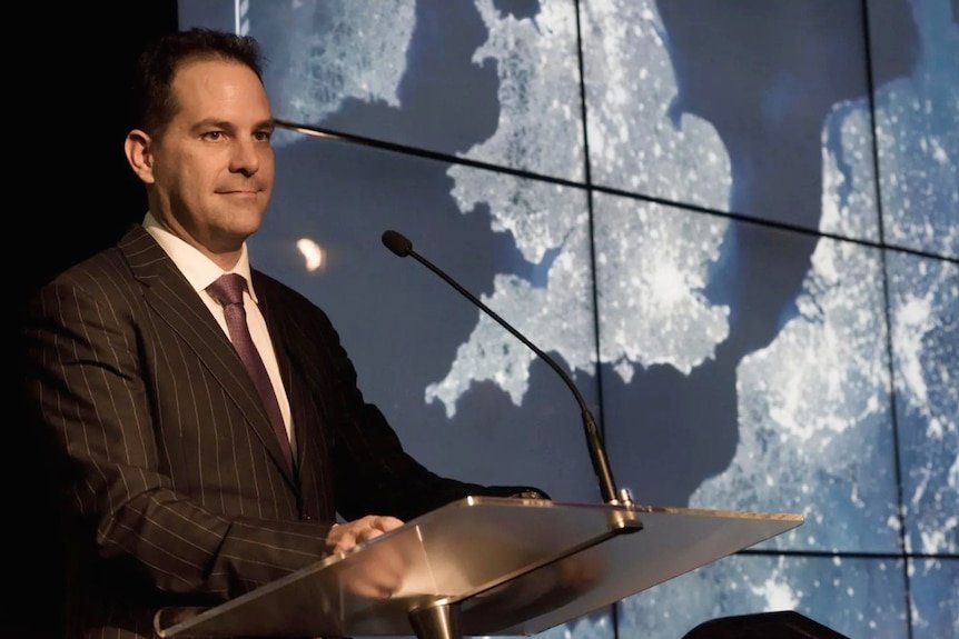 Dr Stuart Minchin the new head of the Bureau of Meteorology standing behind a lecturn