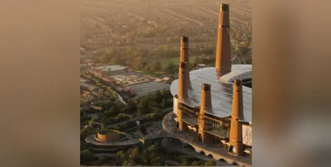 The city of Birmingham part of the stadium is bathed in sunlight in an aerial view, with five towers visible with crowds milling around the ground and around a circular section on the left.