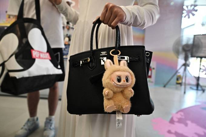 The designer Lapopo art toy hangs on a shopper