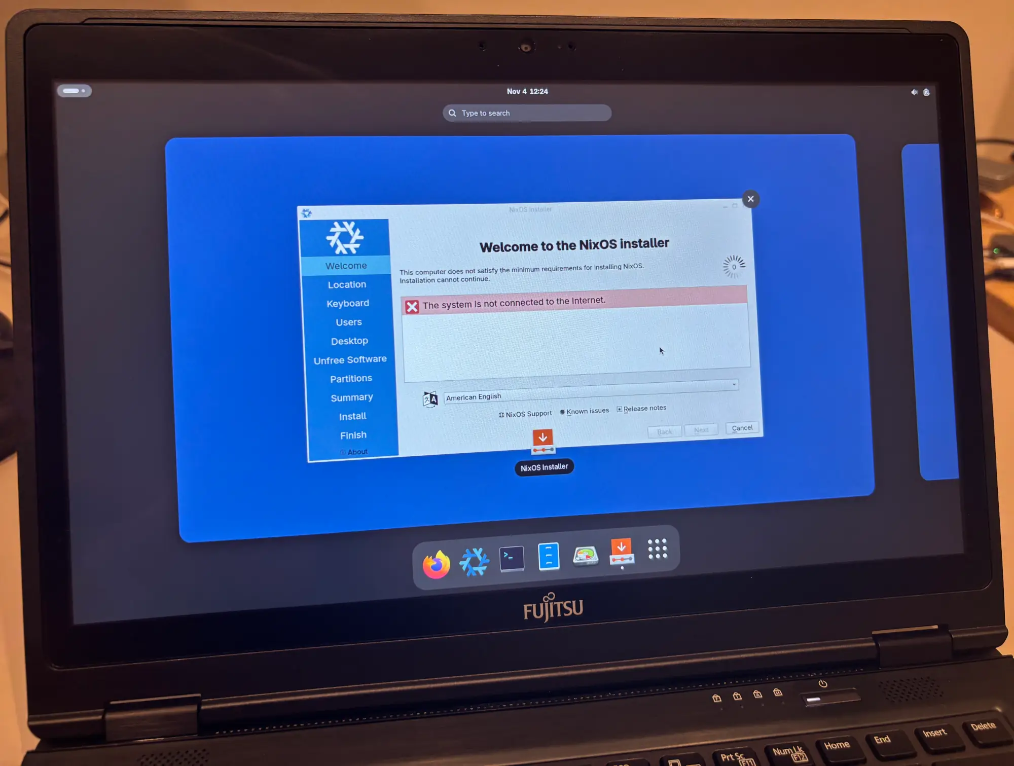 A photograph of the laptop, showing the NixOS installer.