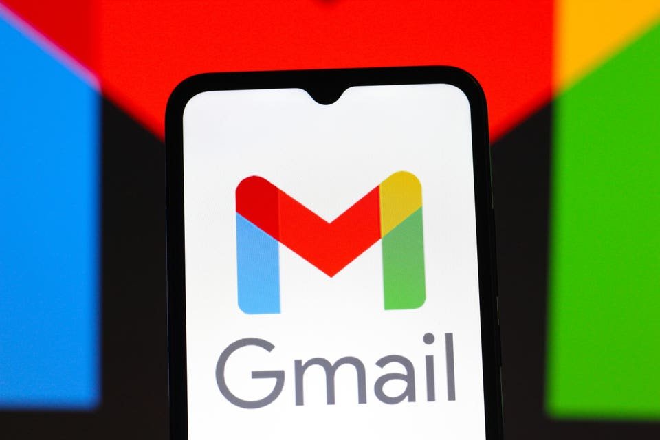 Gmail logo on a smartphone, with Google colors in background of image.