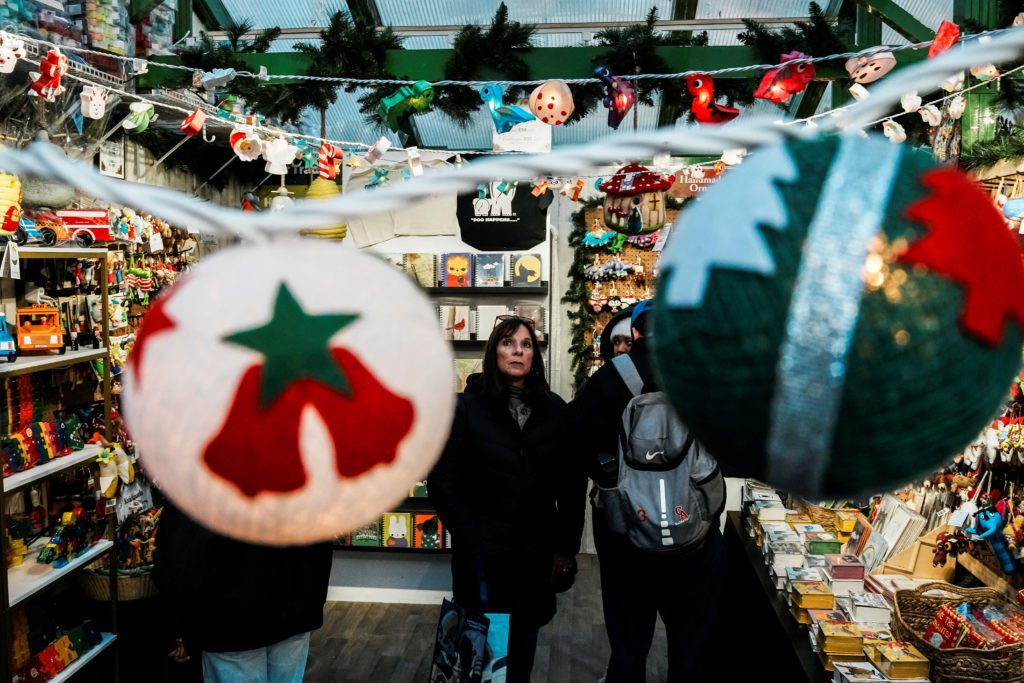 People shop for Christmas items at a holiday market in New York