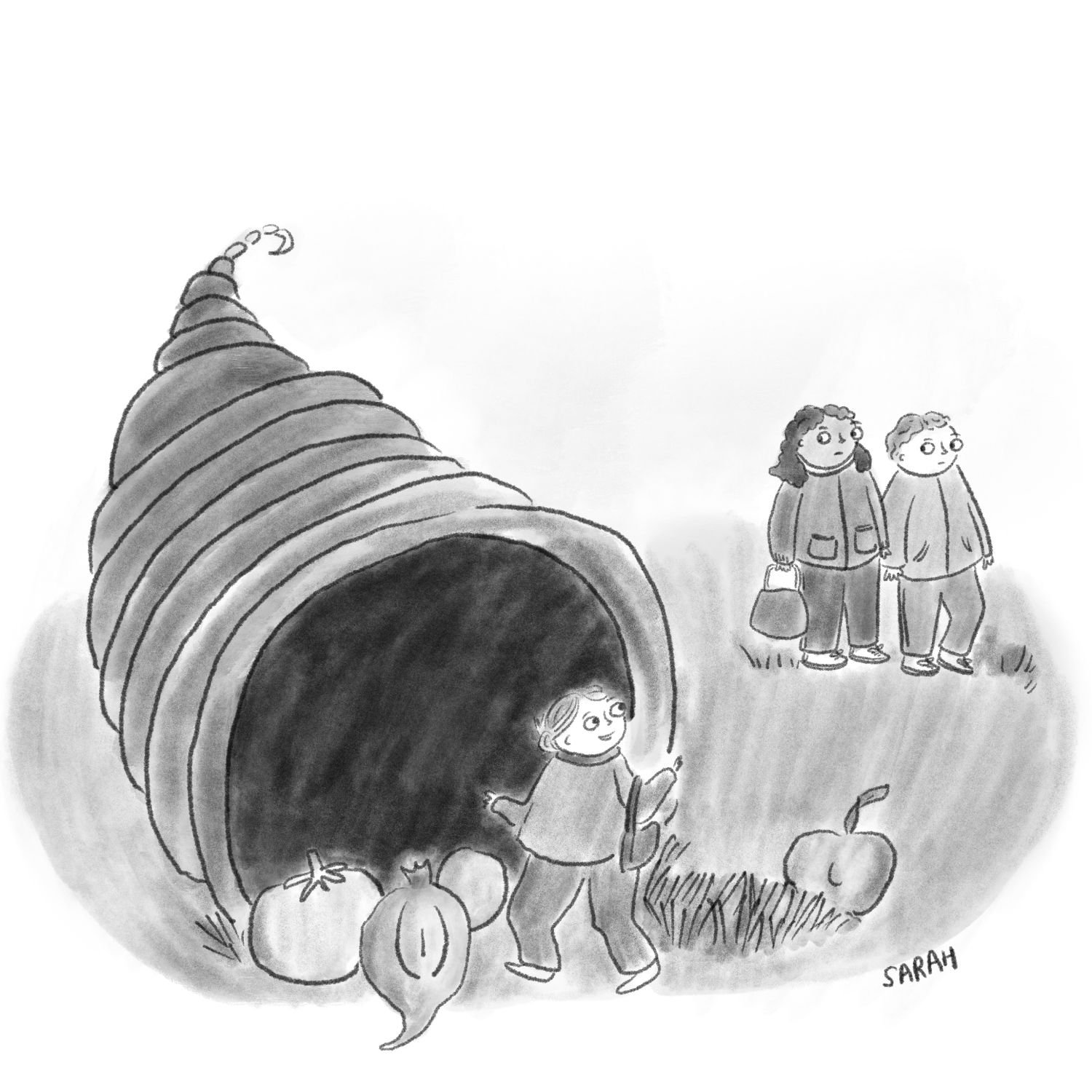 A person stands in front of a cornucopia of Thanksgiving while two people walk next to him.