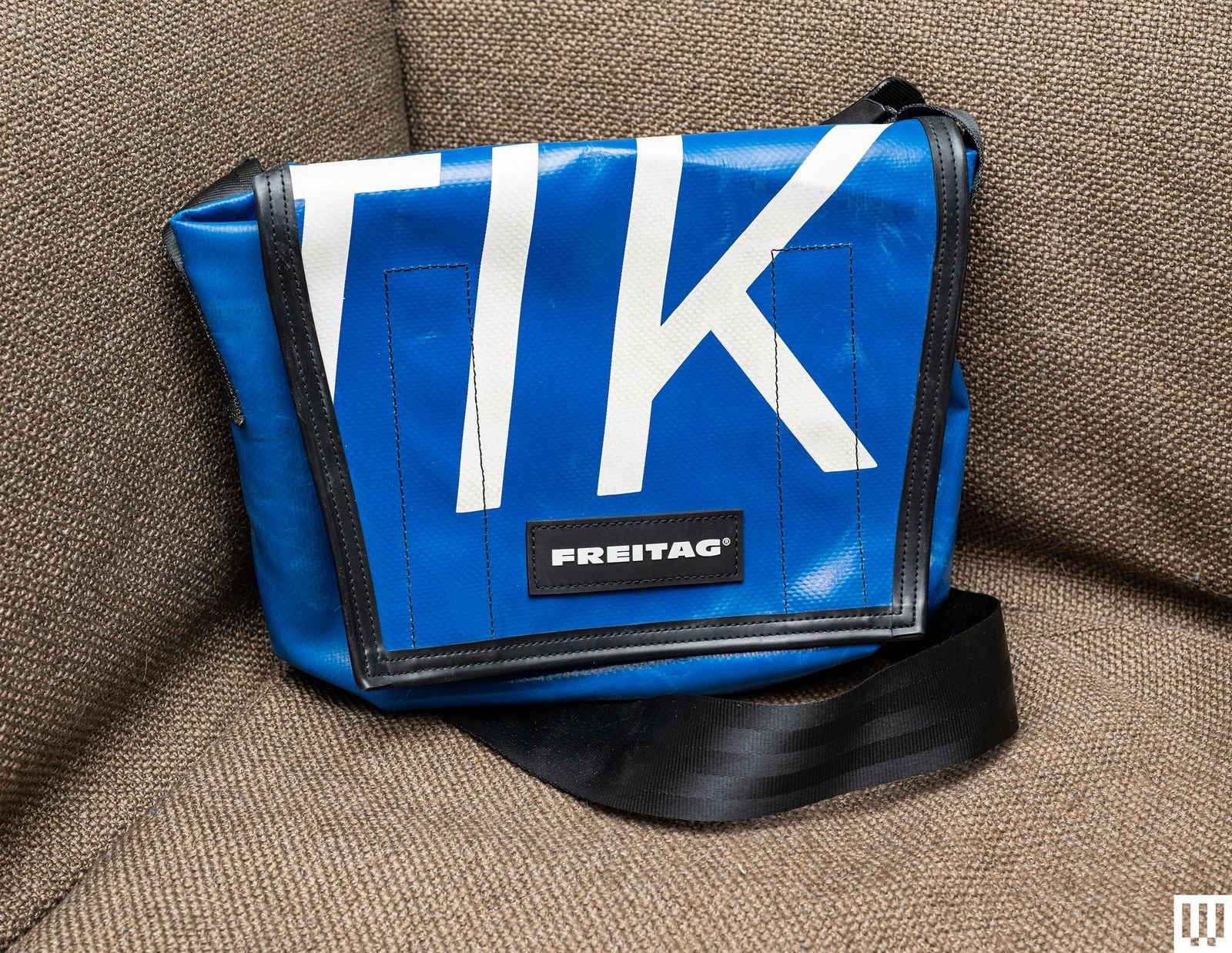 Front of blue bag with large white letters