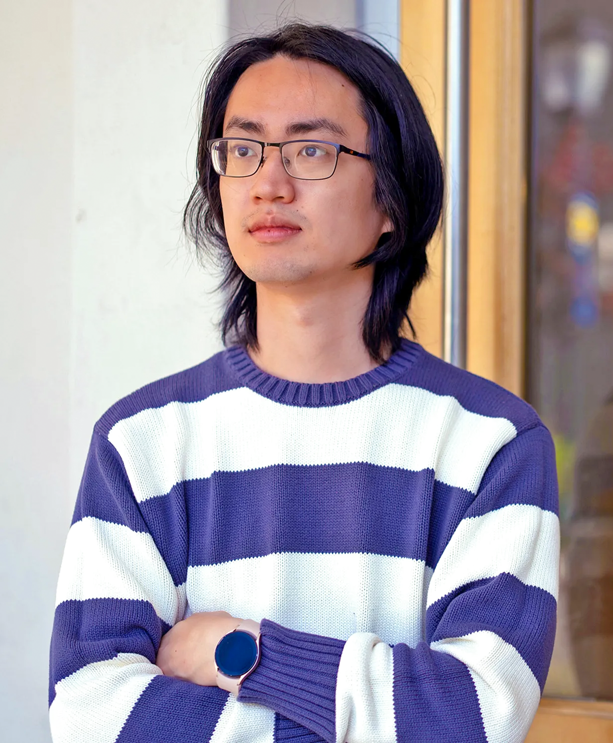 A man in a purple-and-white striped sweater.