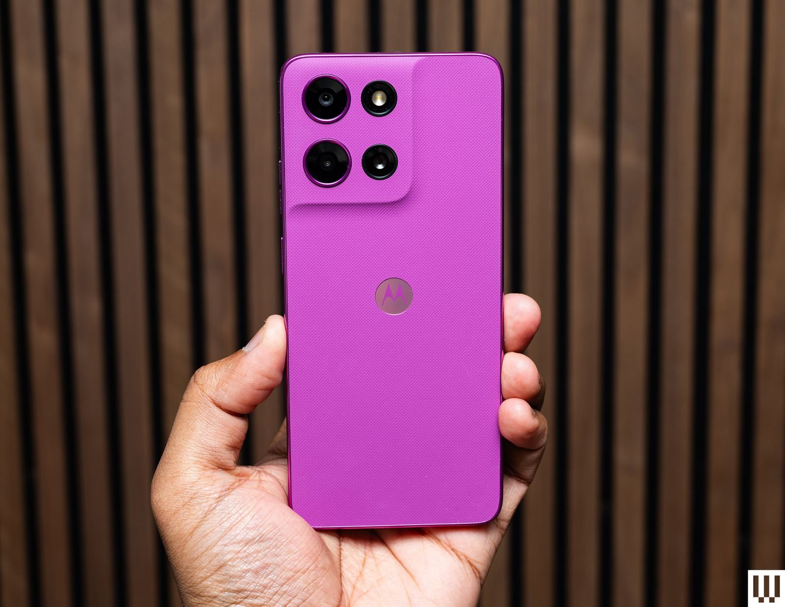 A hand holds a pink Moto G 5G 2026 phone, showing the cameras on the back