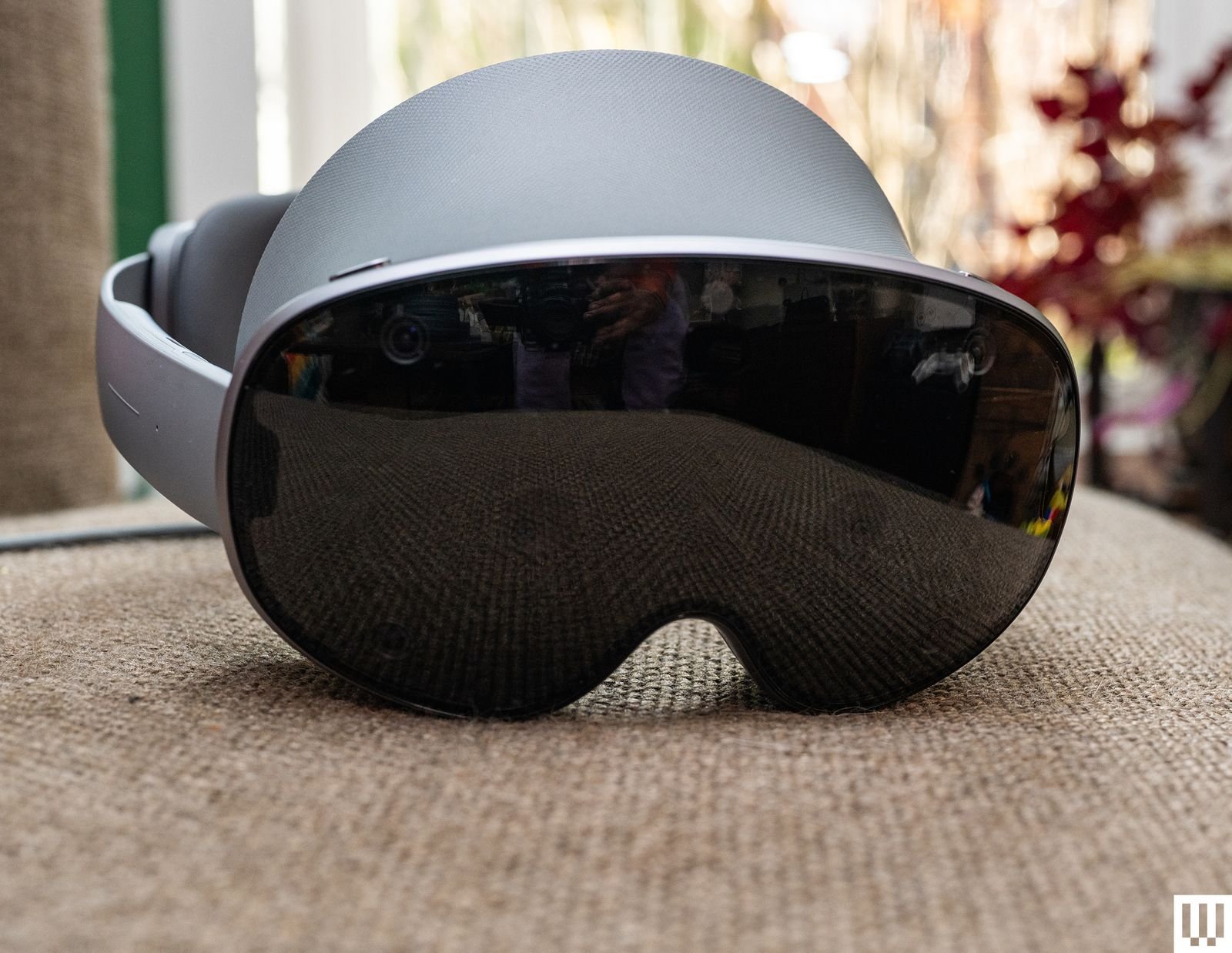 Silver augmented reality headset with a large black lens on the front