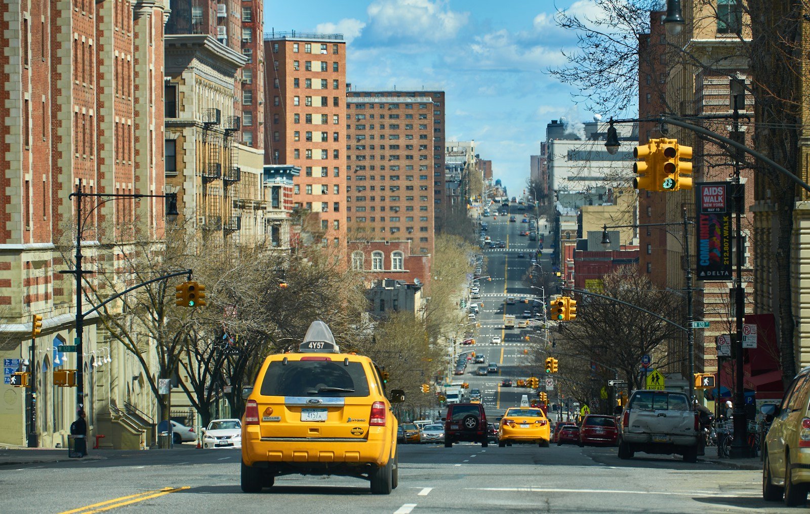 yellow cab on road during daytime