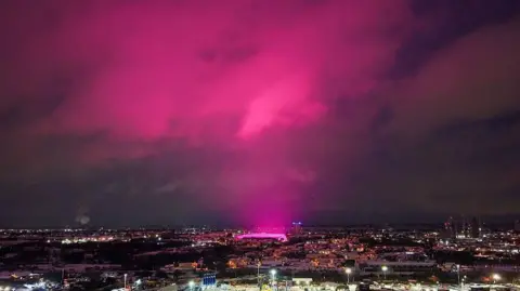 Getty Images An aerial shot of Birmingham city center shows a vibrant pink glow, coming from St Andrew