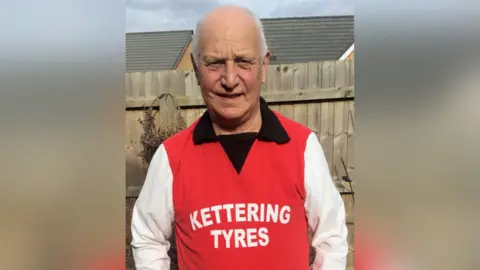 Bryan Lewin Bryan Lewin is wearing a replica from the 1976 Kettering Town kit. It is red with a black collar and white sleeves "Kettering tires" Printed with white line down the middle.