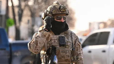 Roberto Schmidt/Getty ICE agent in Minneapolis on January 24
