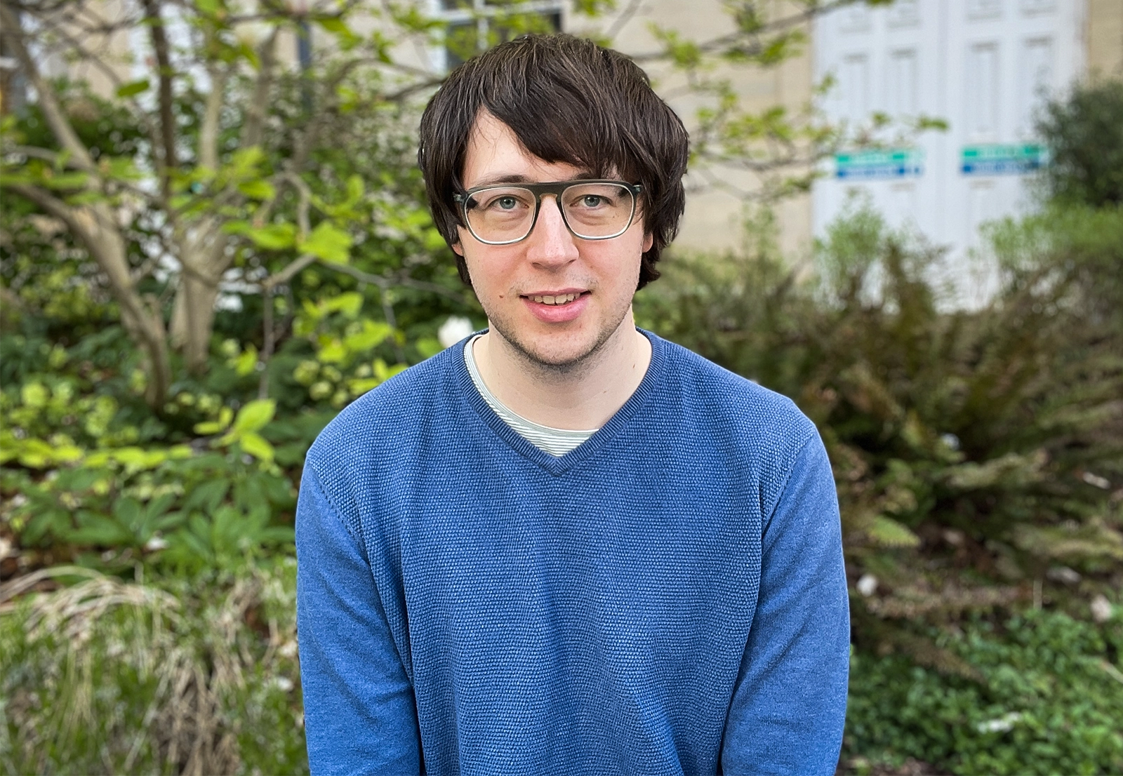 Man wearing glasses and a blue sweater.