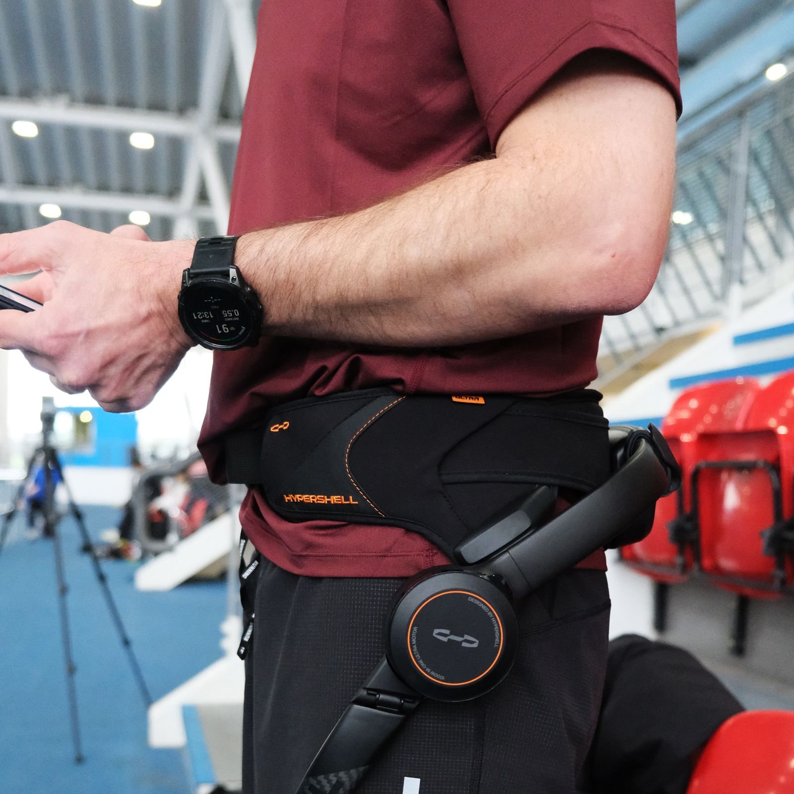 The image may contain adult sports tennis racket, tennis racket accessories, handbag, watch and belt