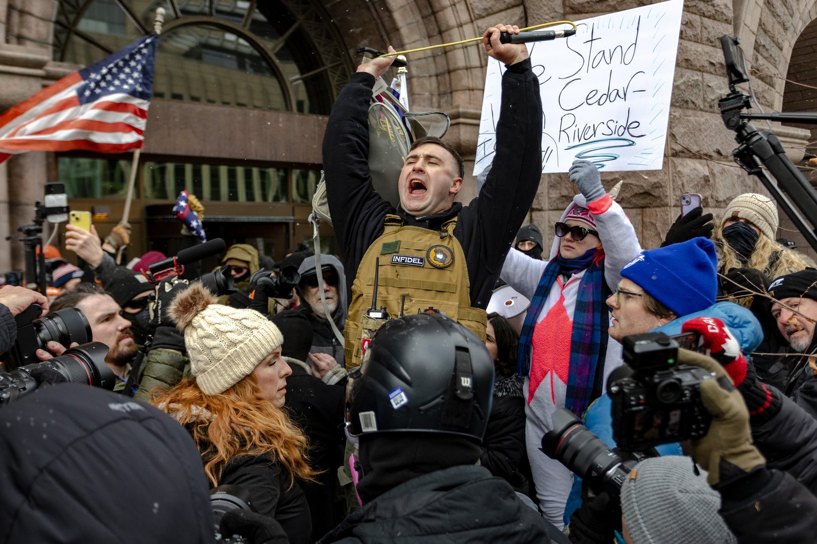 Right-wing influencer Jake Lange confronts protesters at a rally near City Hall.