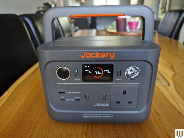 Jackery Explorer 300 Plus, a large, square battery-shaped device in gray with a handle on top, ports on the front face, and a small screen.