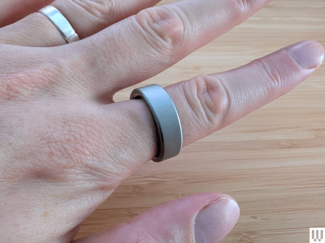 Image may contain: body part, finger, hand, person, accessories, jewelry, ring, baby, silver