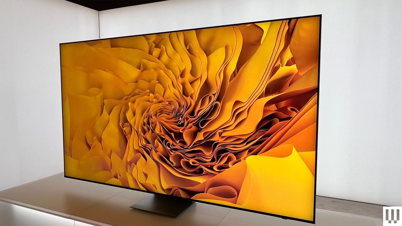 Side view of a Samsung RGB Micro LED TV as the screen shows vibrant yellow folds of abstract art