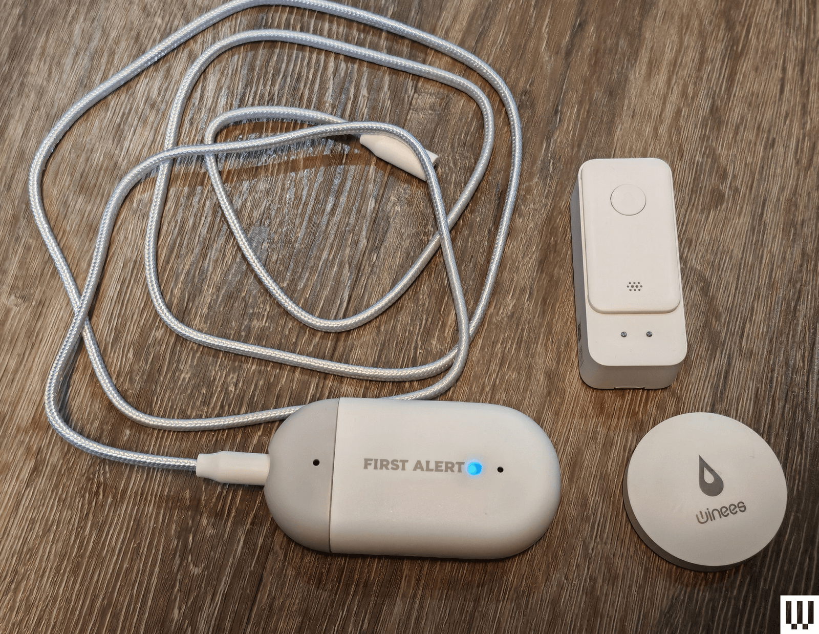 Three different water leak detectors in different shapes, each equipped with a long cord