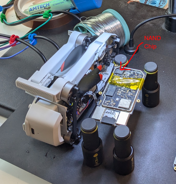Drone and mainboard, partially taped off with heat-shielding tape. The mainboard was still connected via the flex cable while we were searching for debug pins.