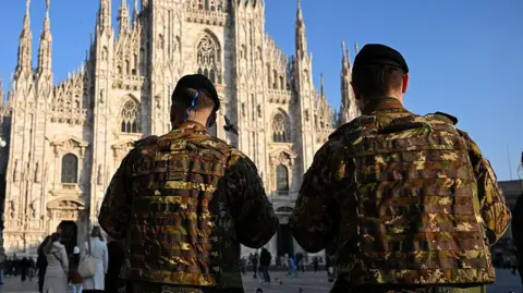Piero CRUCIATTI/AFP Italian soldiers stand guard outside a cathedral in Milan
