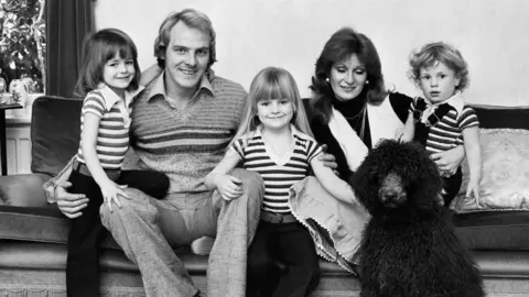 Getty Images Terry Yorath and his family in a black and white photo. His wife, Christine, along with his daughters, Louise, and son, Daniel.