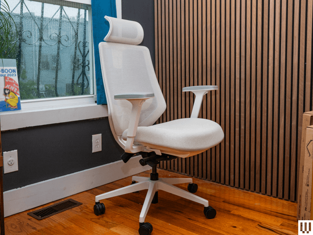 Image may contain: interior design, chair, furniture, wood panels, desk