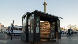 A newsstand in paris in busy square.