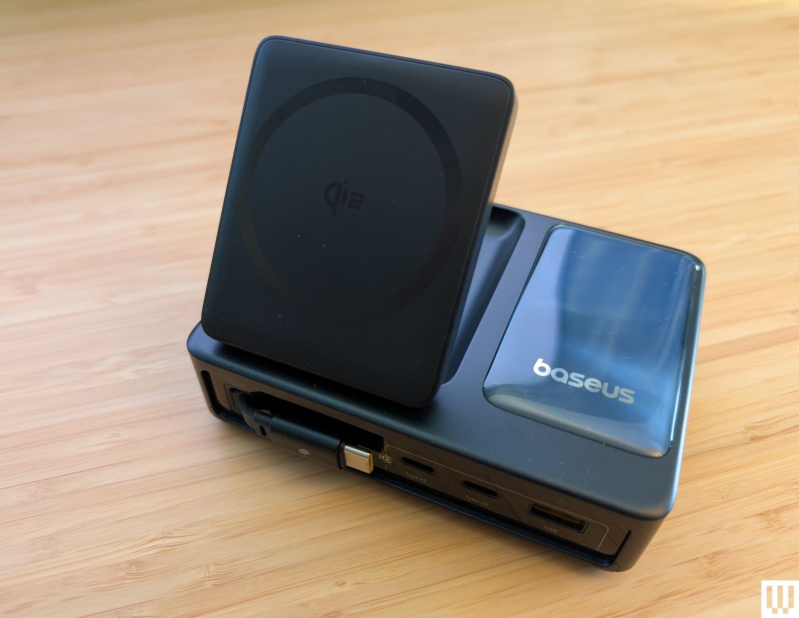 The Baseus Nomos is a rectangular charging station with a plate that tilts up to support the phone