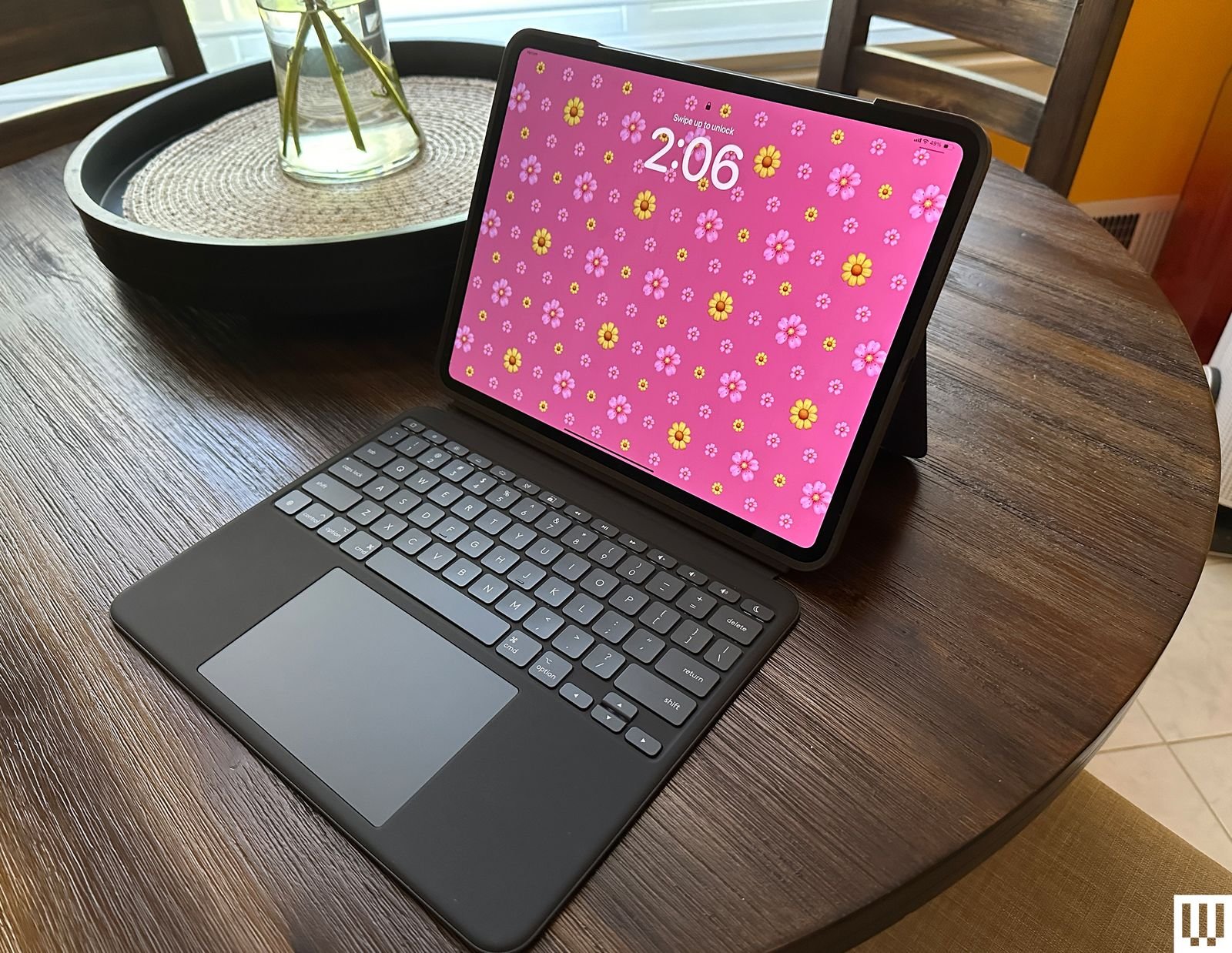 Logitech Combo Touch A black tablet mounted on a white kickstand connected to a detachable black keyboard