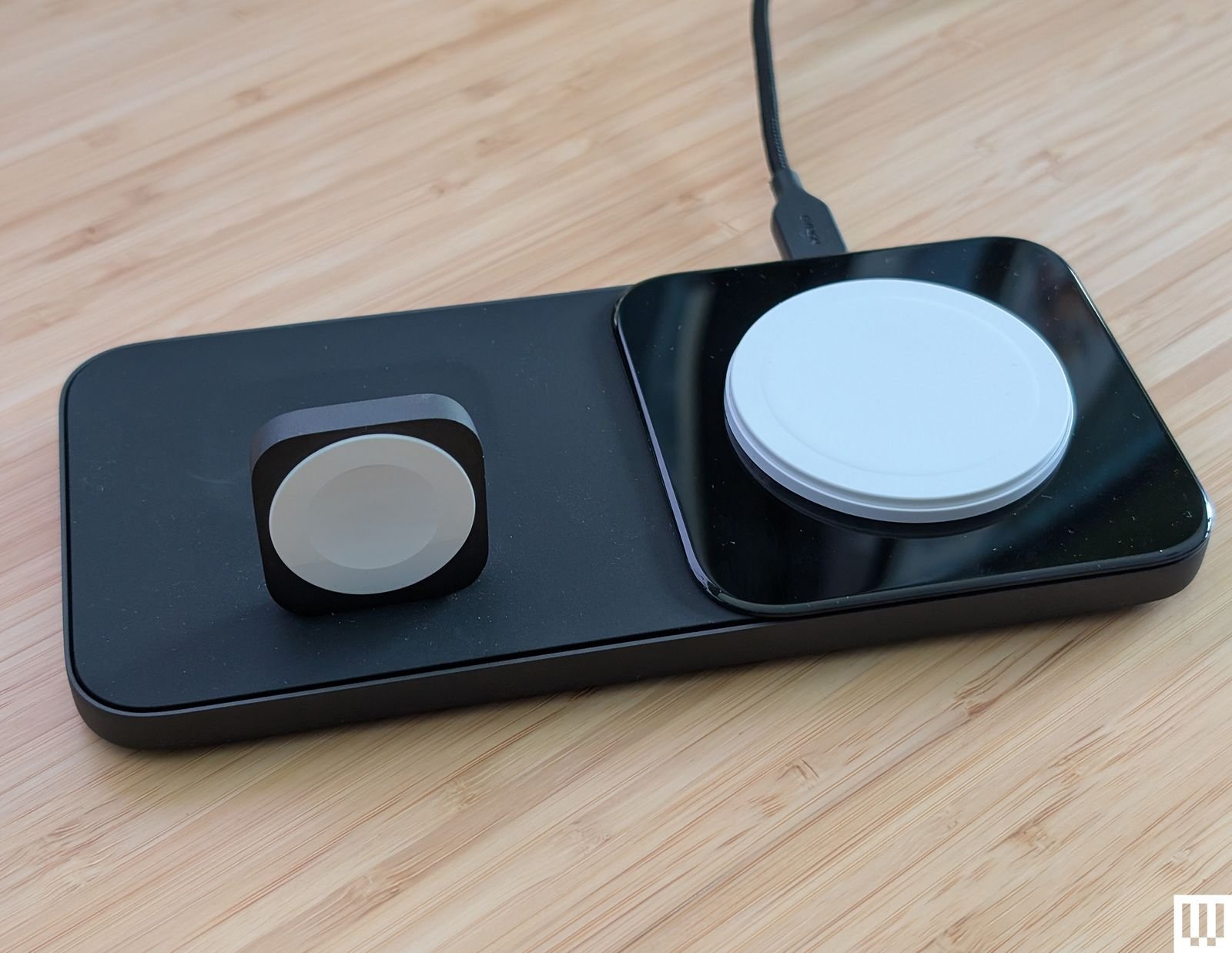 The Nomad Base One Max is a flat black panel with a standing square for wrapping the watch and a flat dial for placing the mobile phone...