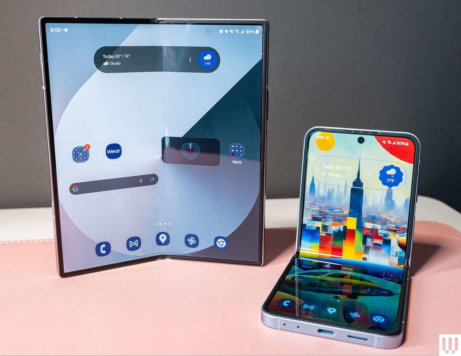 Two foldable mobile phones side by side, one in portrait mode. position and the other in the L-shaped hinge...