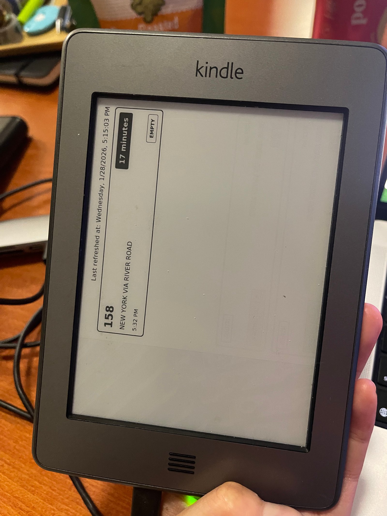 An image of bus arrival times on a Kindle, but the image is horizontally aligned