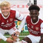 FA Cup winners’ medal, Odegaard badge and illustrated dictionary with Arteta