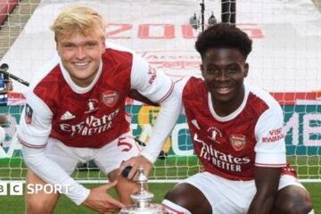 FA Cup winners’ medal, Odegaard badge and illustrated dictionary with Arteta