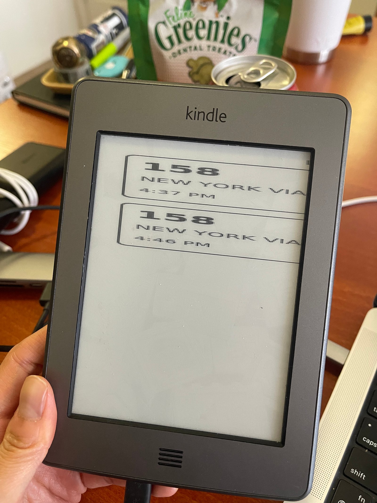 An image of bus arrival times on a Kindle, but the image is horizontally aligned and skewed horizontally