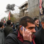 An explosion rocks a state-organized march in Tehran after an Israeli warning