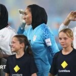 Iranian footballers sing and salute the national anthem at the Asian Cup after a prior silence