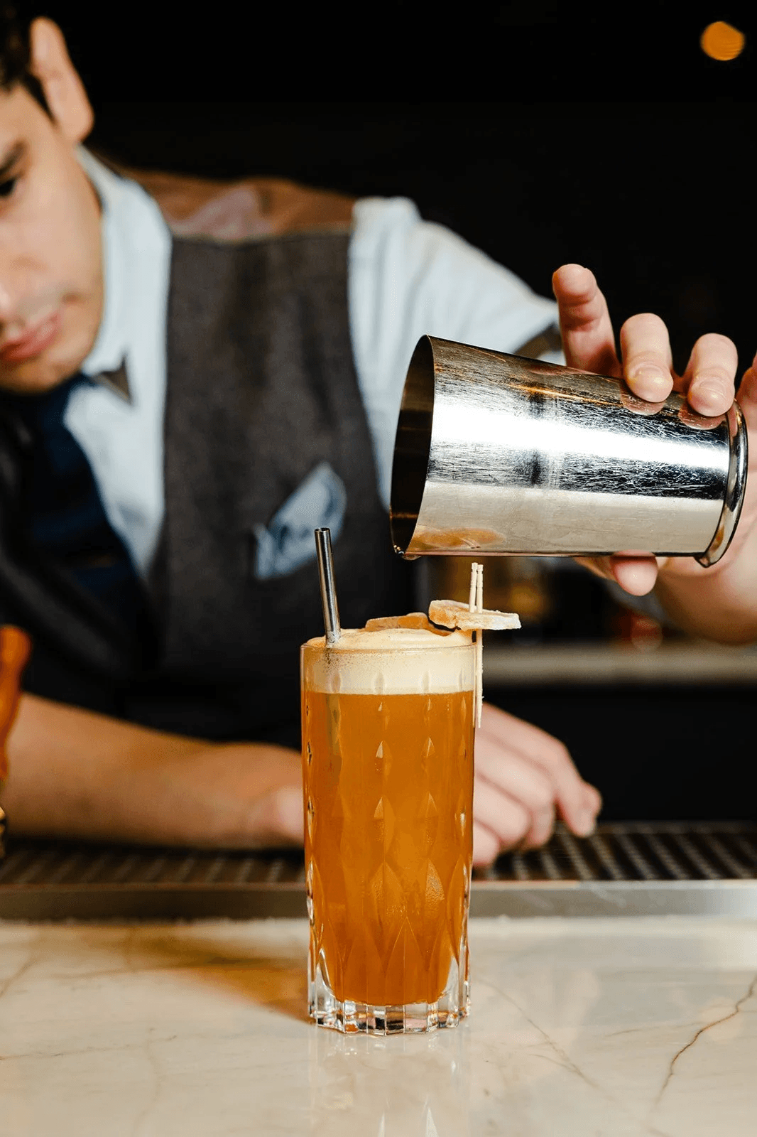 Image may contain Alcohol Beer Beverage Cup Cooking Food Pouring Food Glass Bottle Shaker Soda Face and Head