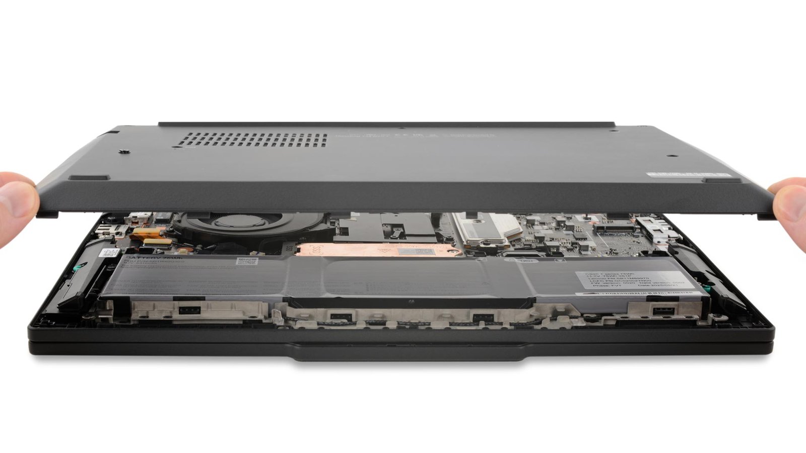 A technician lifts the back cover off of the new ThinkPad T14 laptop