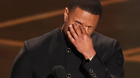 Image source Getty Images Image caption Michael B. Jordan reacts with his emotions on stage while accepting the Best Actor award